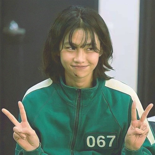 Young female participant in green tracksuit with determined expression